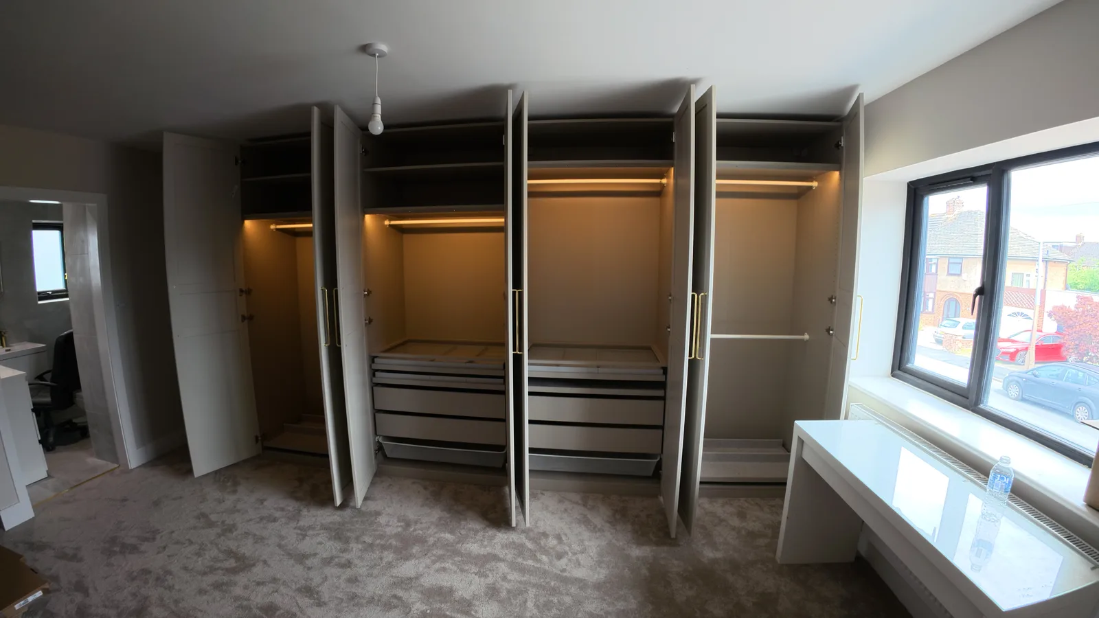 Bespoke fitted wardrobes — open with LED lighting